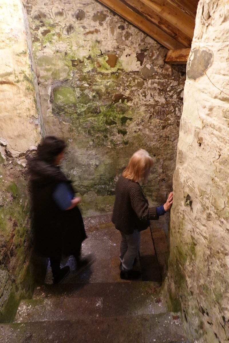 Making our way down a narrow stone stairwell with Lolly.