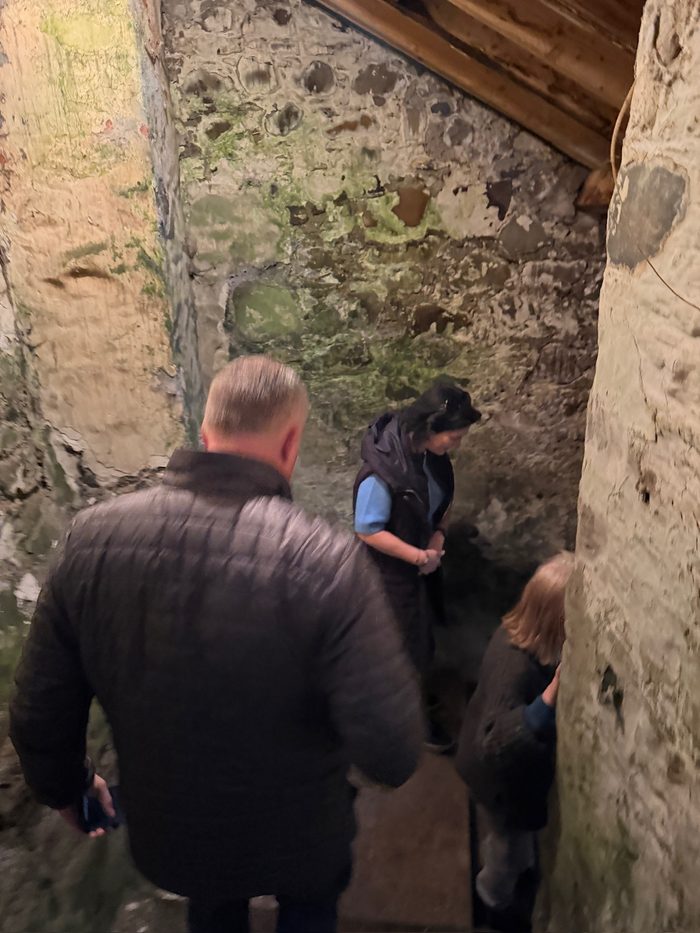 A low mossy stone chamber just inside, three of us gathered together.